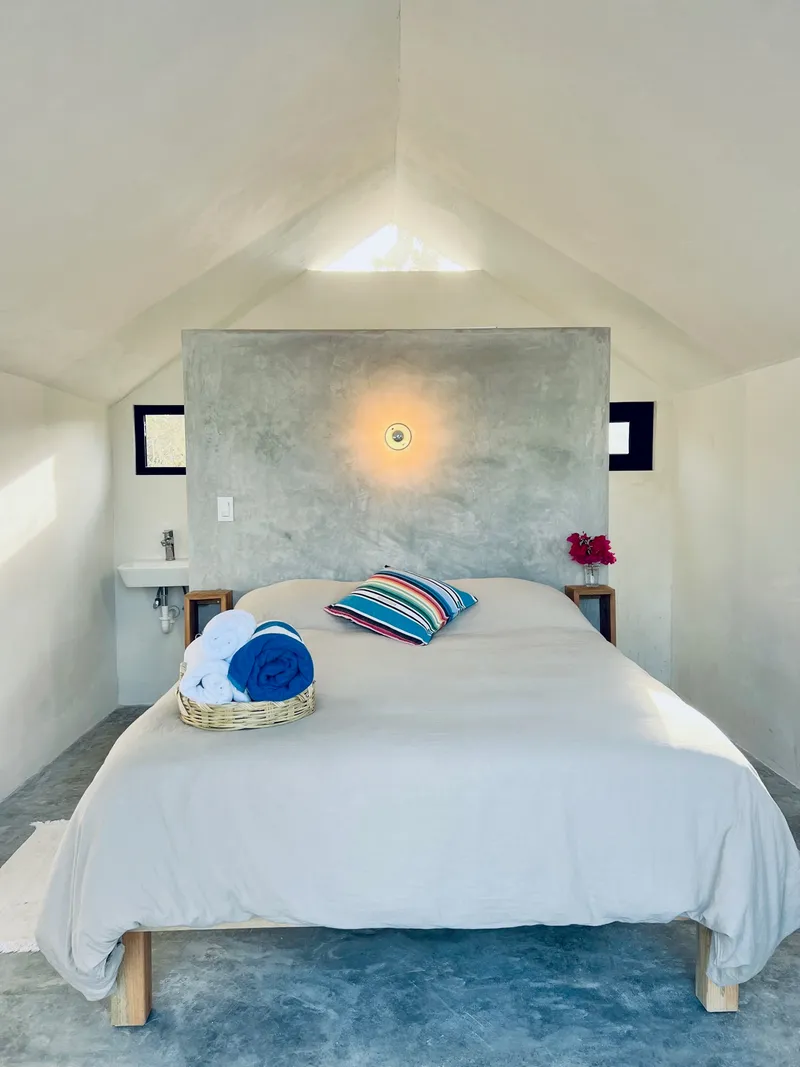 A white cabana bedroom with a made bed
