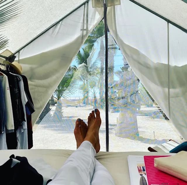 View from inside a glamping tent, looking out to palms and the beach, at the Ceremonia Baja California retreat