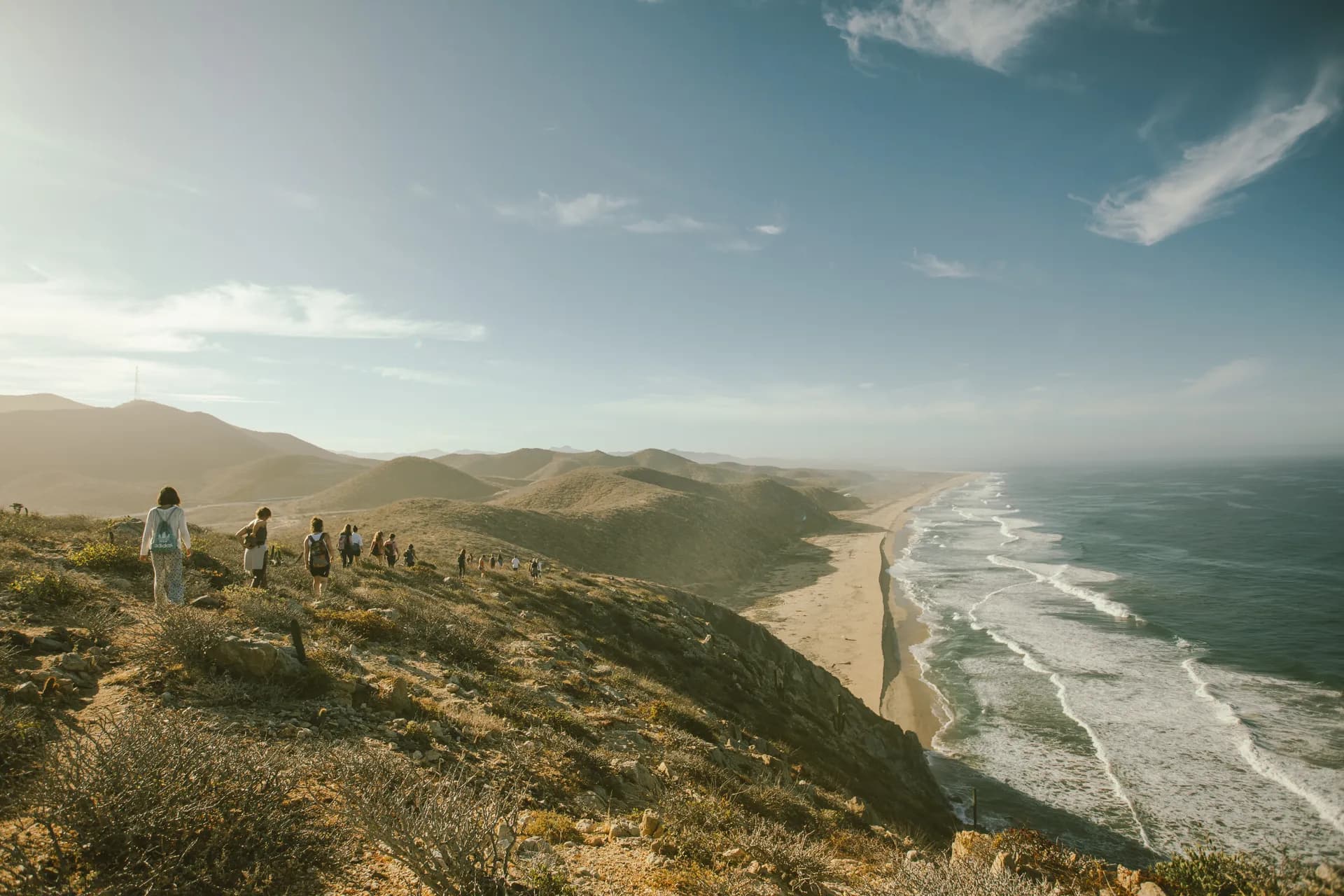 A group hike along a coastal ridge above the ocean near the Ceremonia Baja retreat