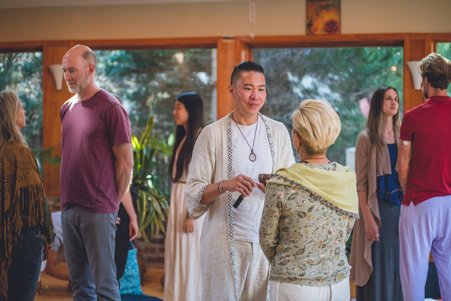 Alumni gathered around a table, a community built through shared work