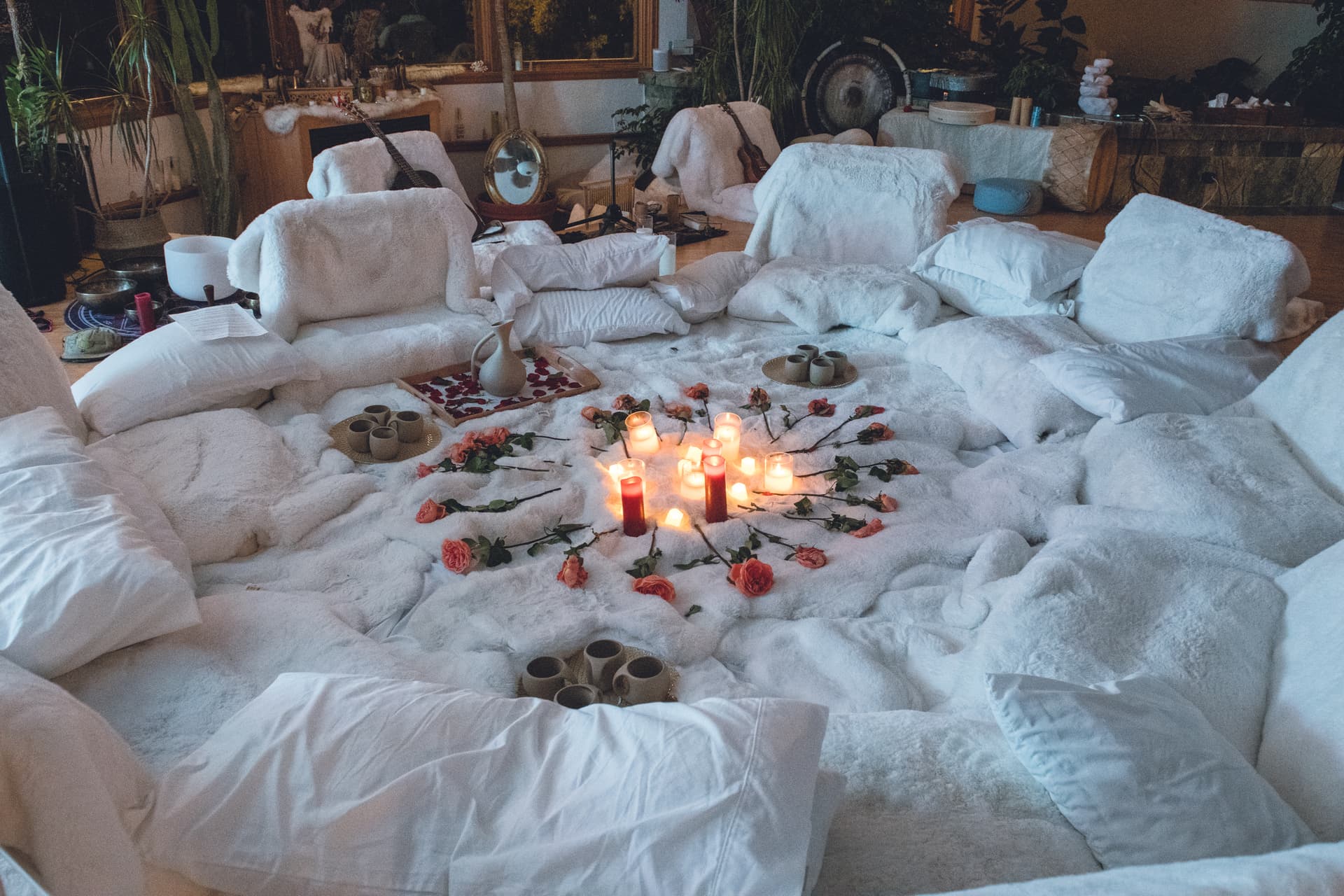 Ceremony materials laid out: cushions, candles, and flowers