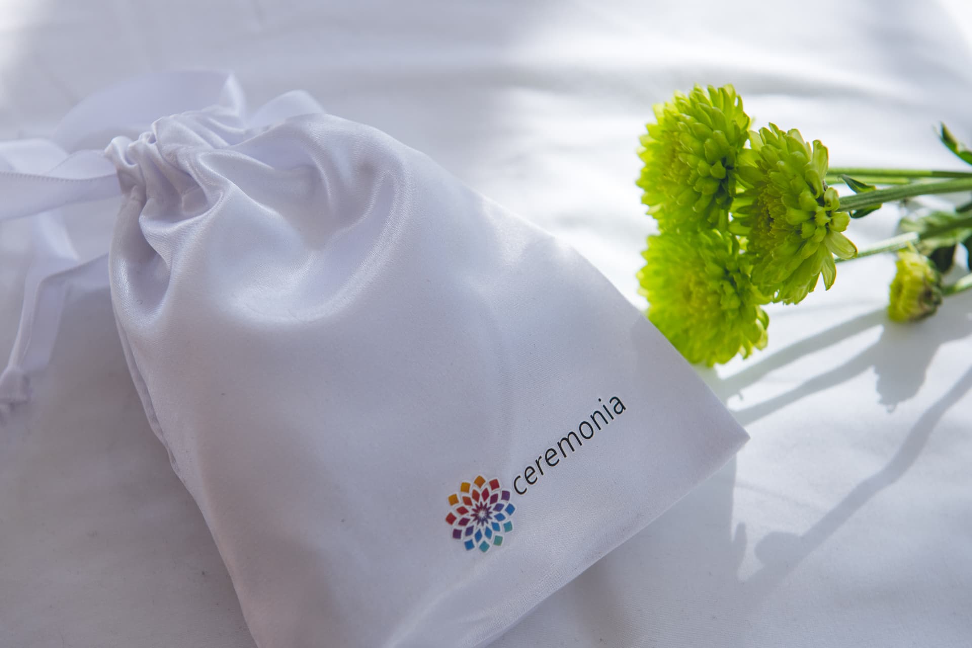 A single flower placed on white ceremony cloth, detail from the ceremony space