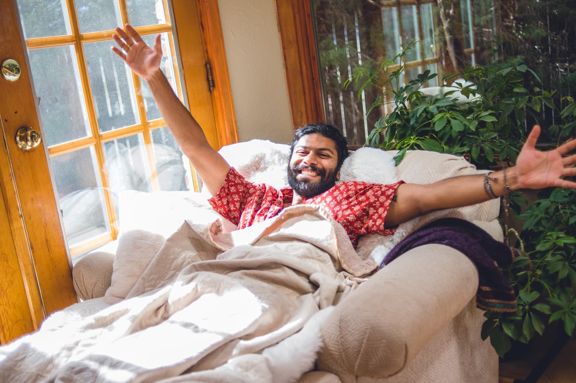 A participant in open-armed rest after a ceremony session