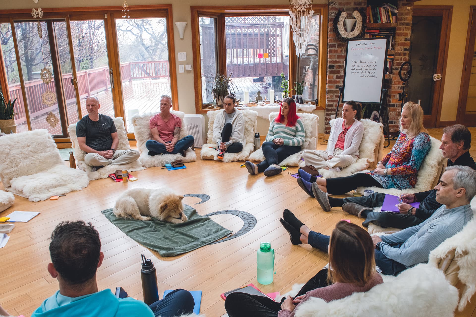 A group sitting in a circle on the floor during a Ceremonia retreat